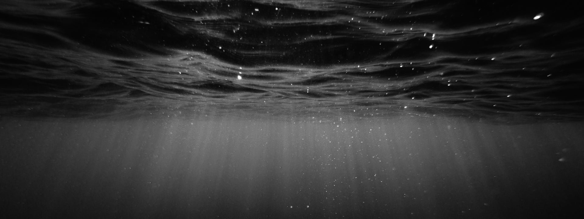 Underwater and lights. Original photo by Cristian Palmer on Unsplash, link: https://unsplash.com/photos/clear-blue-body-of-water-XexawgzYOBc